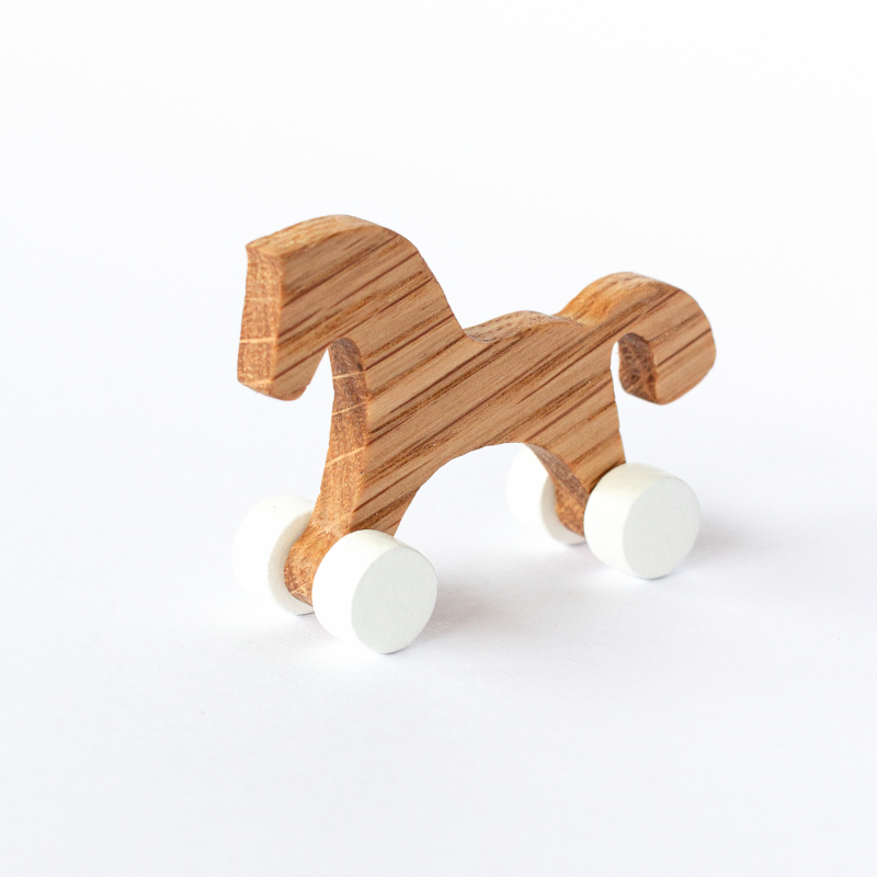 Mini wheeled horse – oak body, white wheels, three-quarter view
