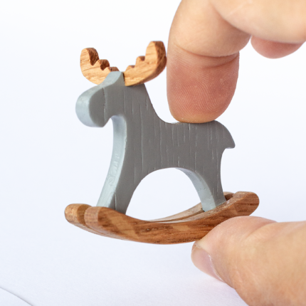 Miniature rocking elk held in fingers – actual size reference for 1:12 dollhouse