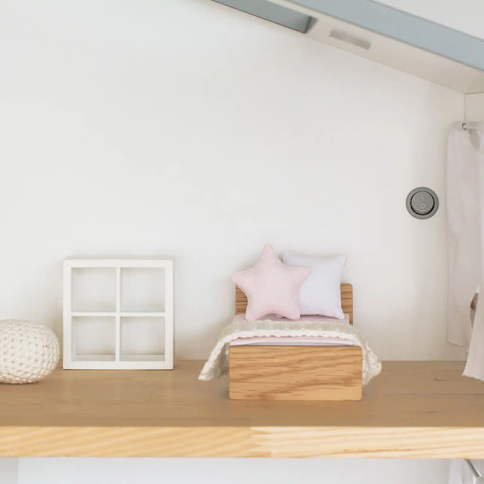 Dollhouse kids room furniture: bed with star pillow, wooden KALLAX-style rack, hand-knitted pouf and blanket