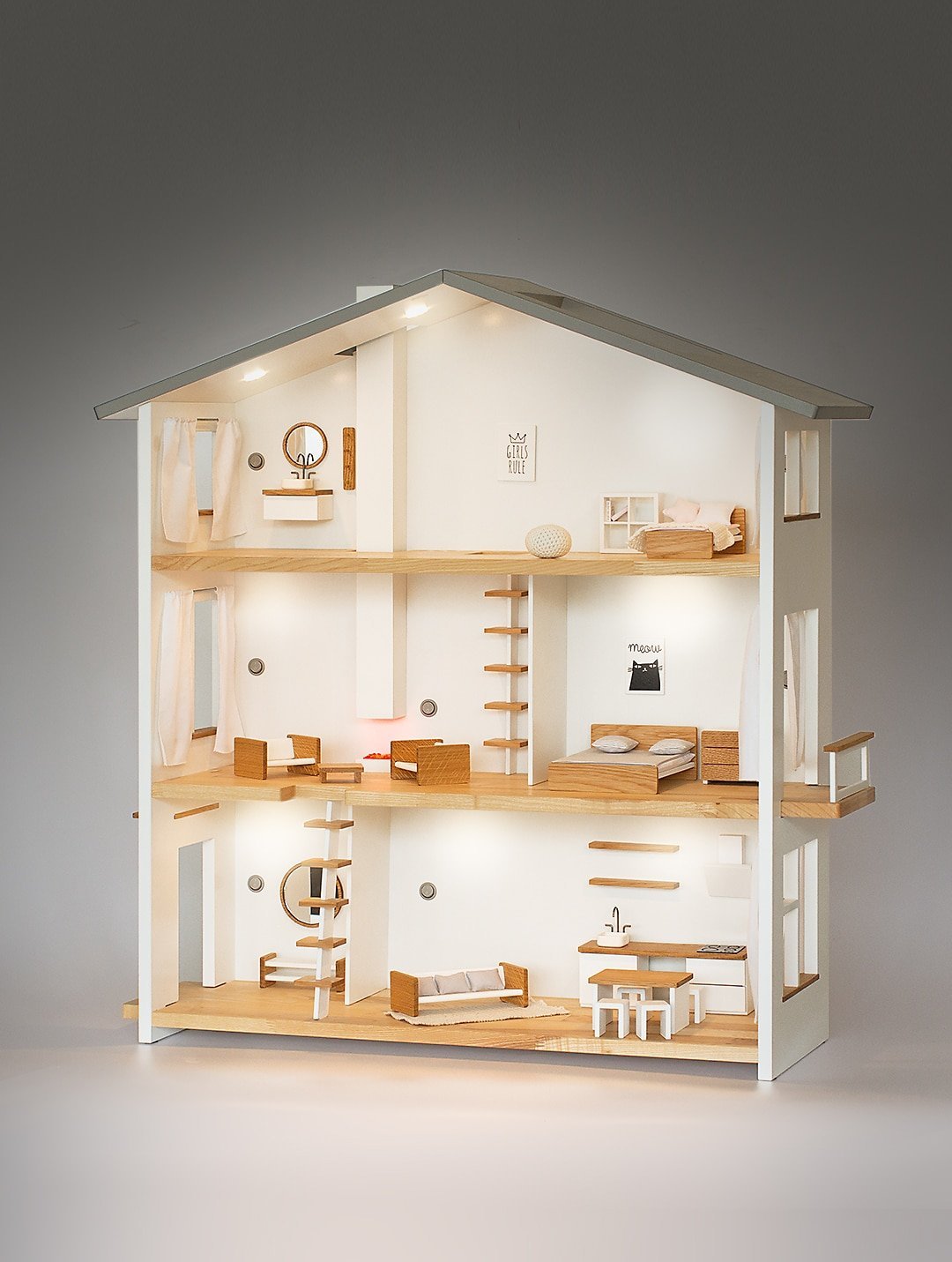 Katin Domik wooden dollhouse with working lights glowing warmly in a dark room – all rooms illuminated