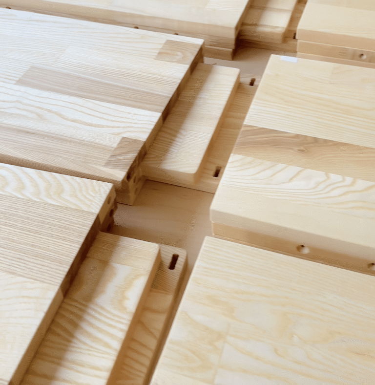 Close-up of solid Balkan ash wood grain on dollhouse shelves – durable natural material with rich texture