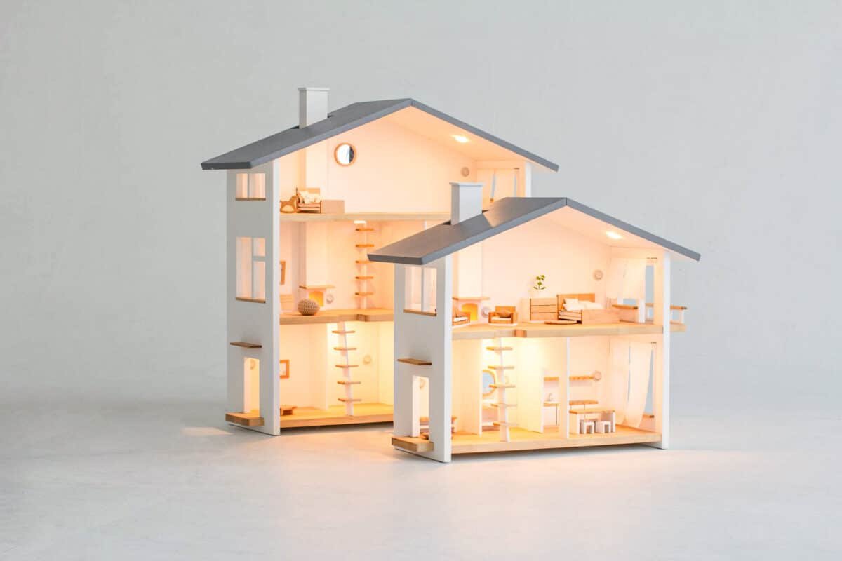 Two Katin Domik wooden dollhouses with lights in a child's room