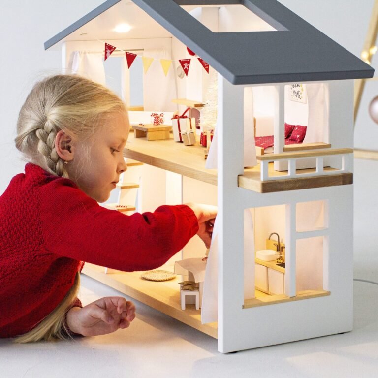 Girl playing with a modern design wooden dollhouse with working LED lights – Katin Domik