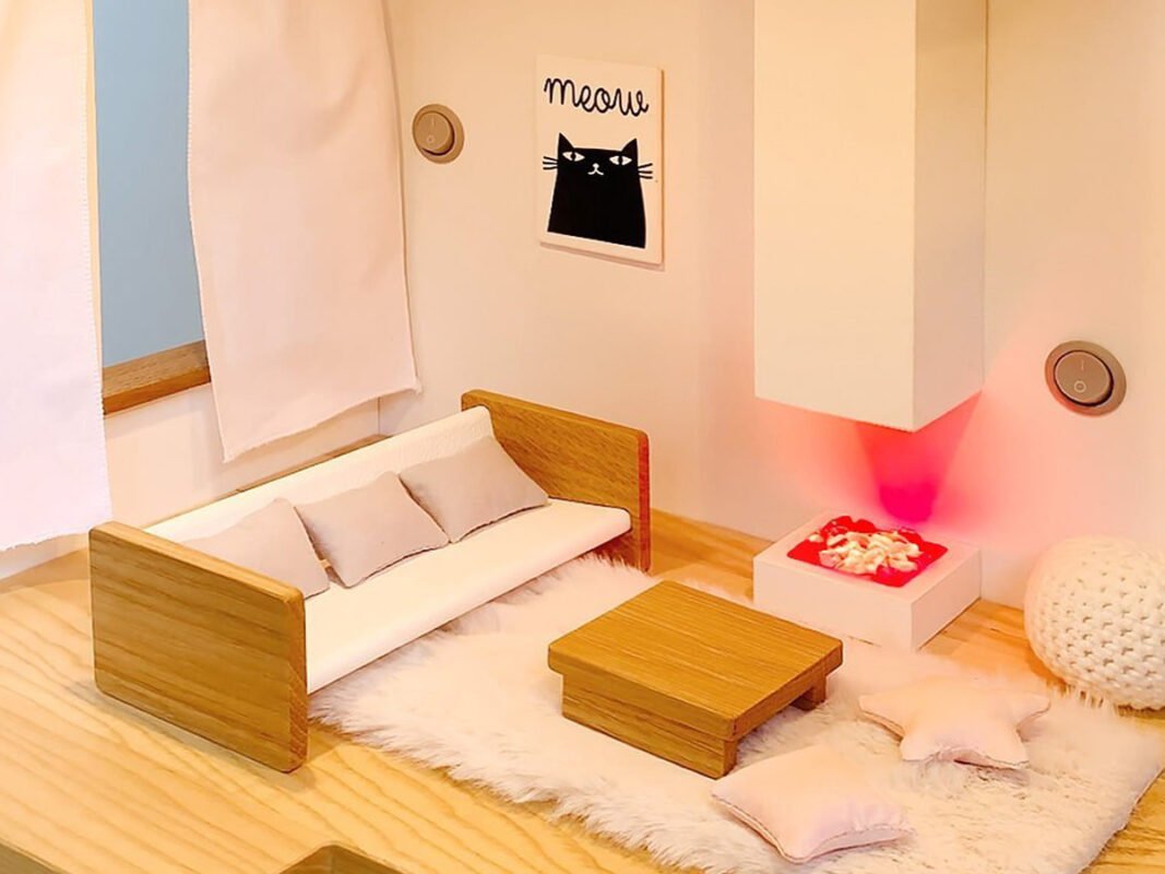 Katin Domik dollhouse living room — room depth allows sofa, coffee table, rug and fireplace with working light