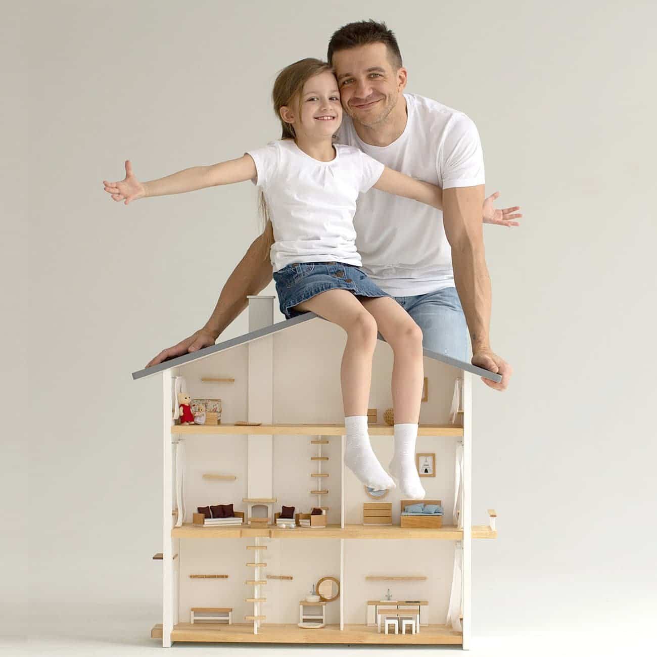 A proud father and his daughter at Katin Domik workshop, demonstrating the durability and safety of a handmade wooden dollhouse