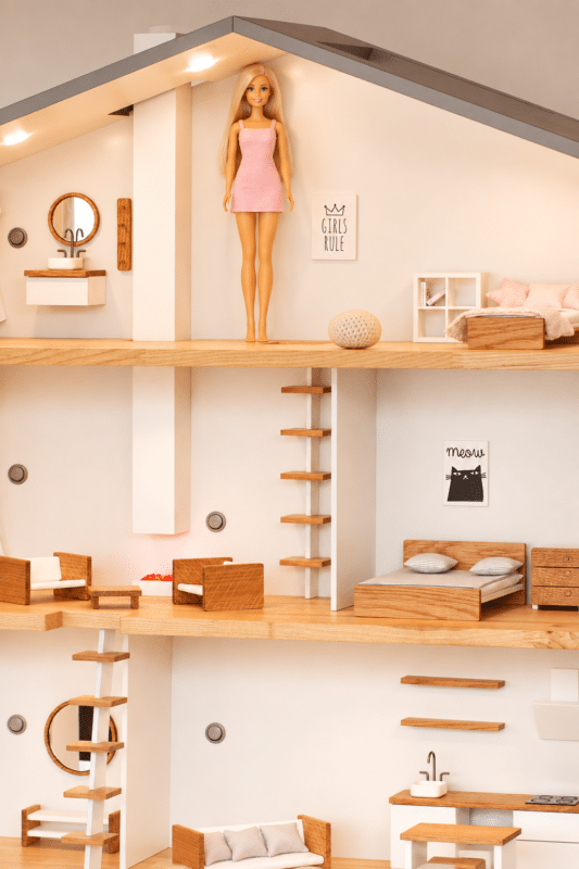Classic Barbie standing inside a 1:12 scale Katin-domik dollhouse